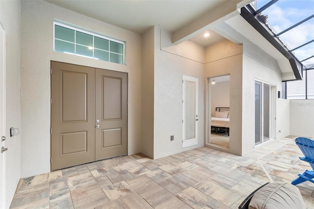 foyer featuring beam ceiling