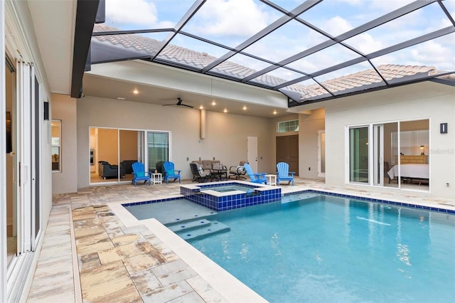 view of pool with a patio, a lanai, a pool with connected hot tub, and ceiling fan