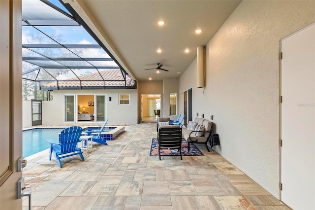 view of patio / terrace with outdoor lounge area, a lanai, an outdoor pool, and ceiling fan