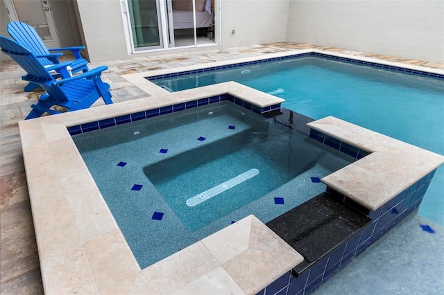 view of swimming pool with a patio area and a pool with connected hot tub