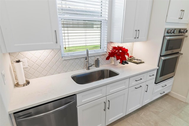 kitchen featuring a sink, light countertops, white cabinets, and stainless steel appliances