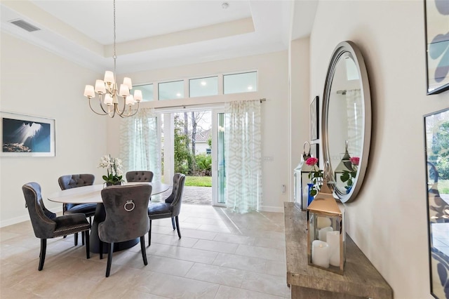 dining space featuring baseboards, visible vents, a raised ceiling, and an inviting chandelier