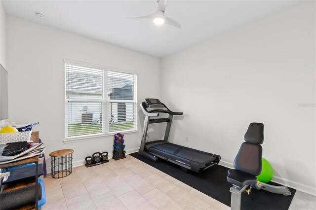 workout area with ceiling fan and baseboards