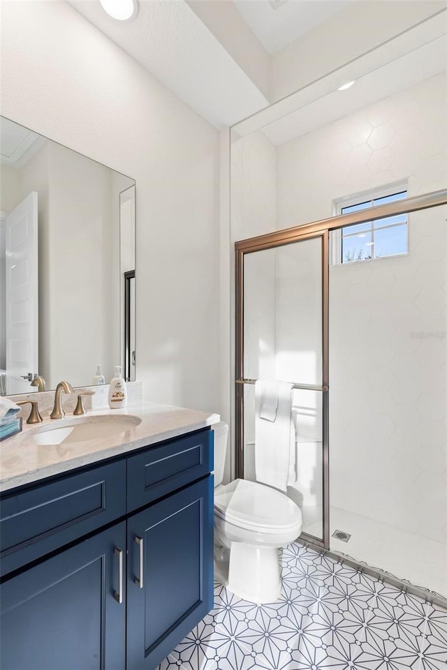 full bath featuring vanity, a shower stall, and toilet