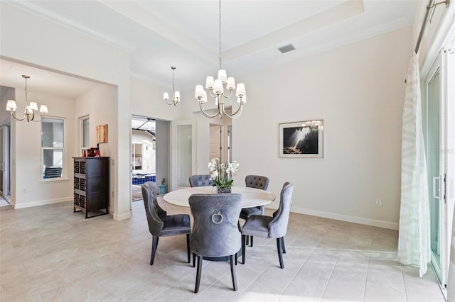 dining area featuring an inviting chandelier, baseboards, a raised ceiling, and ornamental molding