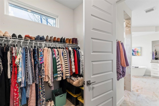 walk in closet featuring visible vents and marble finish floor