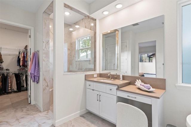 full bathroom with visible vents, marble finish floor, baseboards, walk in shower, and vanity