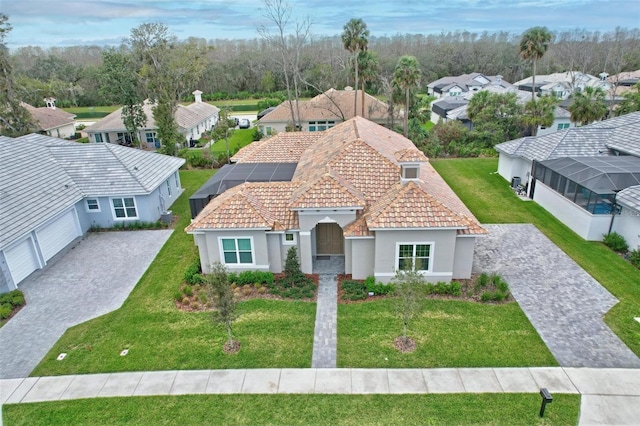 view of front of property with stucco siding, decorative driveway, and a front lawn