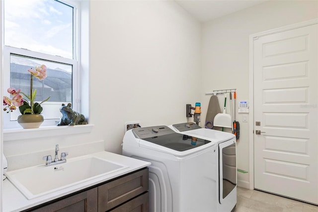 laundry room with a sink, cabinet space, and separate washer and dryer