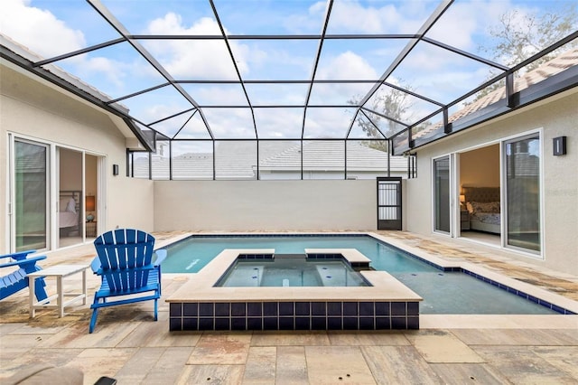 view of pool with a lanai, a patio area, and a pool with connected hot tub