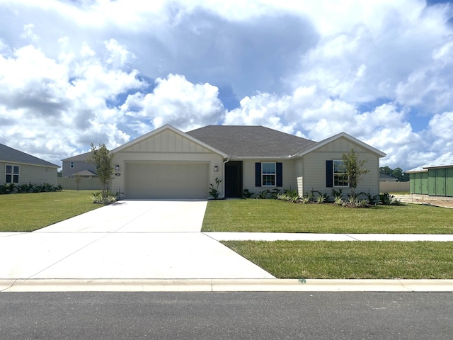 view of front of property with a front yard and a garage