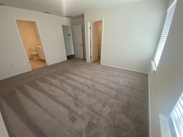 unfurnished bedroom with light carpet and ensuite bathroom