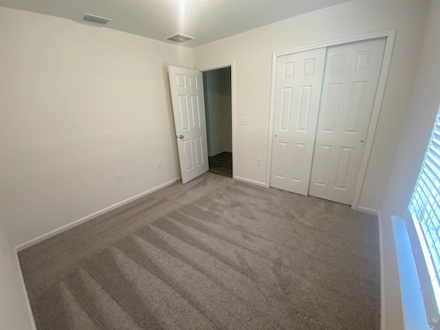 unfurnished bedroom with carpet flooring and a closet