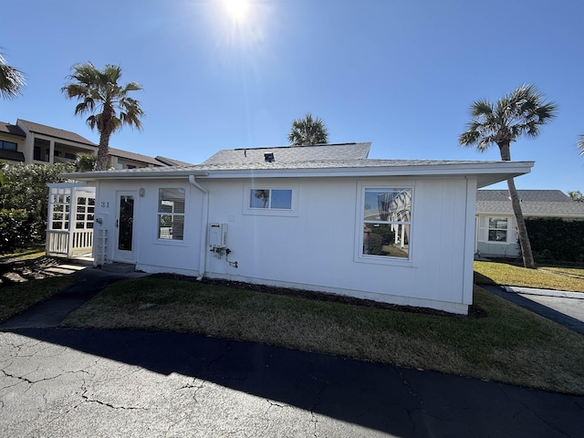 rear view of property with a yard