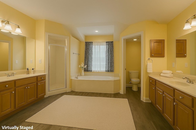 735 E Red House Branch Rd, Saint Augustine, FL 32084 - full bathroom featuring wood finished floors, a garden tub, toilet, a shower stall, and two vanities