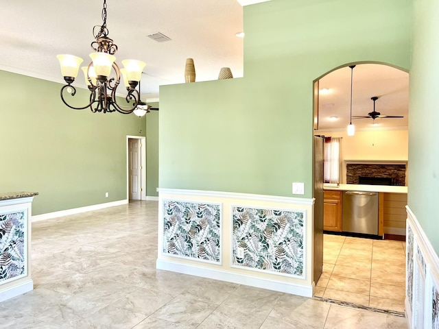 kitchen featuring ornamental molding, visible vents, arched walkways, and stainless steel dishwasher
