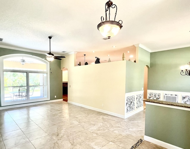 735 E Red House Branch Rd, Saint Augustine, FL 32084 - spare room with crown molding, arched walkways, and ceiling fan with notable chandelier