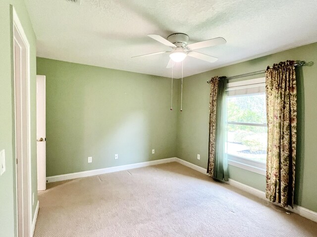 735 E Red House Branch Rd, Saint Augustine, FL 32084 - empty room with a ceiling fan, light colored carpet, baseboards, and a textured ceiling