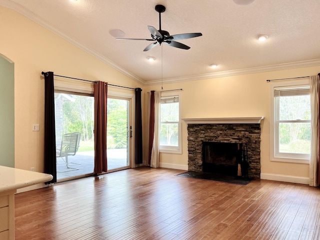 735 E Red House Branch Rd, Saint Augustine, FL 32084 - unfurnished living room with healthy amount of natural light, lofted ceiling, ceiling fan, a stone fireplace, and wood finished floors