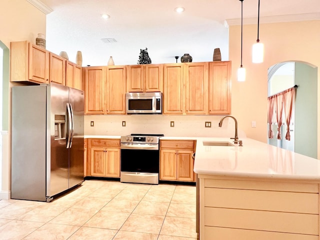 735 E Red House Branch Rd, Saint Augustine, FL 32084 - kitchen with appliances with stainless steel finishes, a sink, a peninsula, arched walkways, and light brown cabinetry