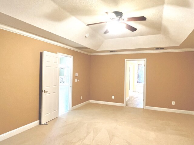 735 E Red House Branch Rd, Saint Augustine, FL 32084 - spare room featuring a tray ceiling, light carpet, a ceiling fan, ornamental molding, and baseboards