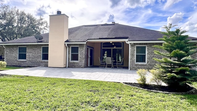 735 E Red House Branch Rd, Saint Augustine, FL 32084 - rear view of property with a lawn, a chimney, a shingled roof, and a patio