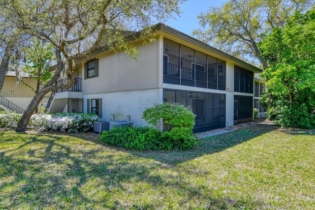 31 Catalonia Ct, Saint Augustine, FL 32086 - view of property exterior featuring a yard, cooling unit, and a sunroom