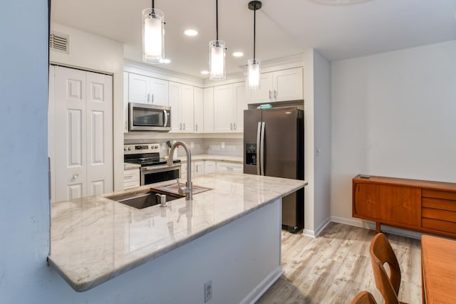 31 Catalonia Ct, Saint Augustine, FL 32086 - kitchen featuring tasteful backsplash, white cabinetry, stainless steel appliances, and light stone countertops