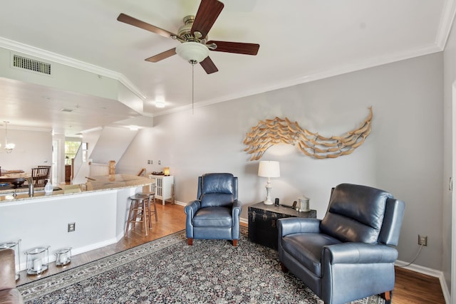 living room with ceiling fan, dark hardwood / wood-style flooring, and ornamental molding