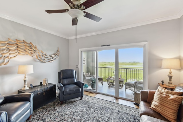 living room featuring crown molding, ceiling fan, and hardwood / wood-style flooring