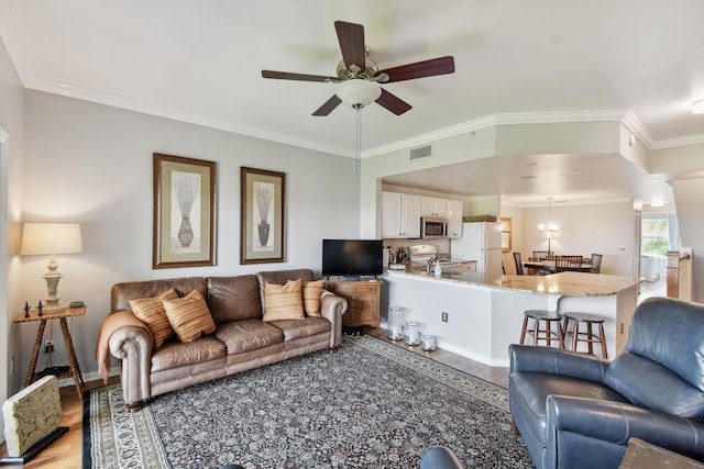 living room featuring ceiling fan, wood-type flooring, and crown molding