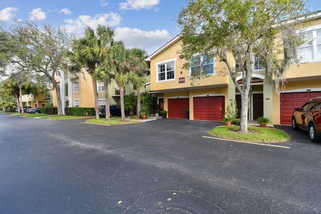 townhome / multi-family property featuring a garage