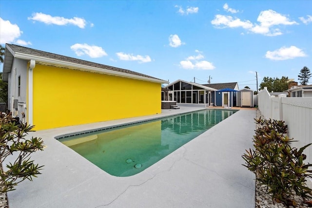 342 Euclid Ave, Daytona Beach, FL 32118 - view of swimming pool with a sunroom, a storage shed, and a patio area