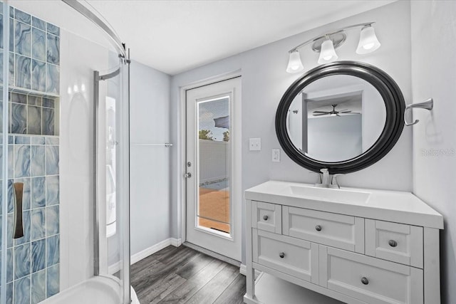 342 Euclid Ave, Daytona Beach, FL 32118 - bathroom with a shower stall, wood finished floors, vanity, and a ceiling fan