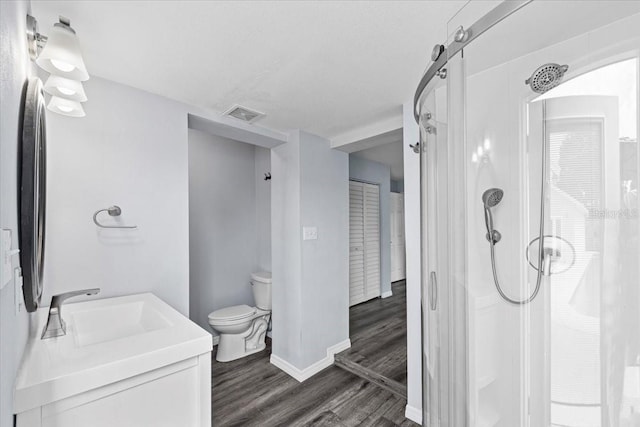 342 Euclid Ave, Daytona Beach, FL 32118 - bathroom featuring walk in shower, vanity, and wood finished floors