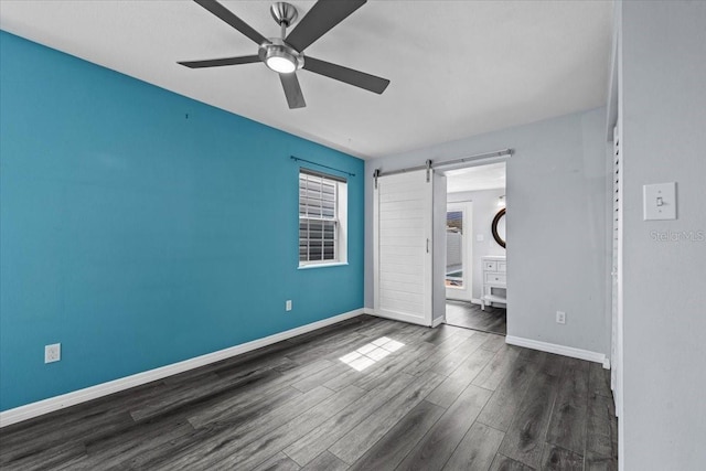 342 Euclid Ave, Daytona Beach, FL 32118 - unfurnished bedroom featuring a barn door, wood finished floors, and ceiling fan