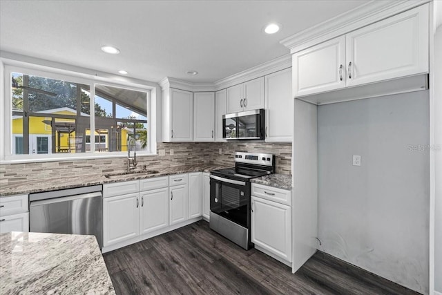 342 Euclid Ave, Daytona Beach, FL 32118 - kitchen with appliances with stainless steel finishes, dark wood finished floors, white cabinets, light stone countertops, and tasteful backsplash