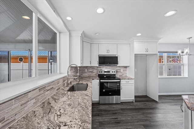 342 Euclid Ave, Daytona Beach, FL 32118 - kitchen with appliances with stainless steel finishes, light stone countertops, white cabinets, and recessed lighting