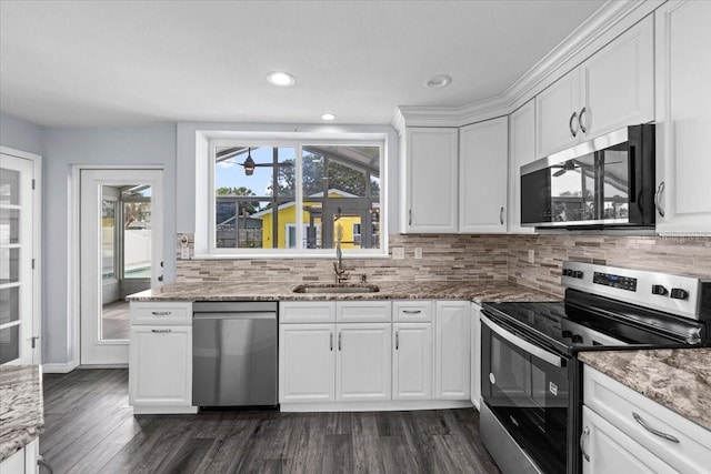 342 Euclid Ave, Daytona Beach, FL 32118 - kitchen featuring stainless steel appliances, dark wood-style floors, white cabinetry, tasteful backsplash, and light stone countertops