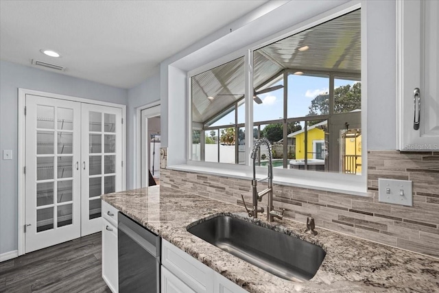 342 Euclid Ave, Daytona Beach, FL 32118 - kitchen featuring stainless steel dishwasher, decorative backsplash, white cabinetry, light stone counters, and dark wood-style floors