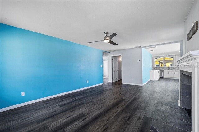 342 Euclid Ave, Daytona Beach, FL 32118 - unfurnished living room featuring dark wood finished floors, ceiling fan, and a tile fireplace