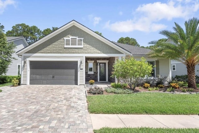 97 Paranza Trce, Saint Augustine, FL 32095 - craftsman house with decorative driveway, an attached garage, a front yard, and stone siding
