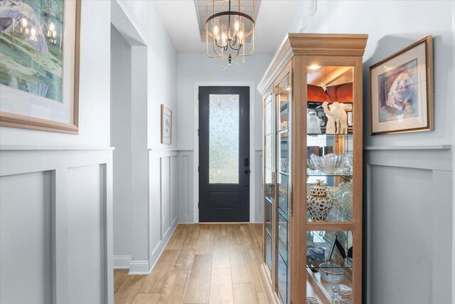 97 Paranza Trce, Saint Augustine, FL 32095 - entrance foyer with light wood-type flooring, a decorative wall, a chandelier, and wainscoting