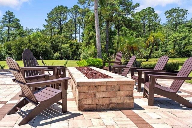 97 Paranza Trce, Saint Augustine, FL 32095 - view of patio / terrace featuring an outdoor fire pit and view of wooded area