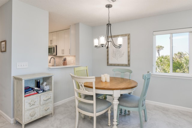 8550 S A1A # 102, Saint Augustine, FL 32080 - dining area with a chandelier and baseboards