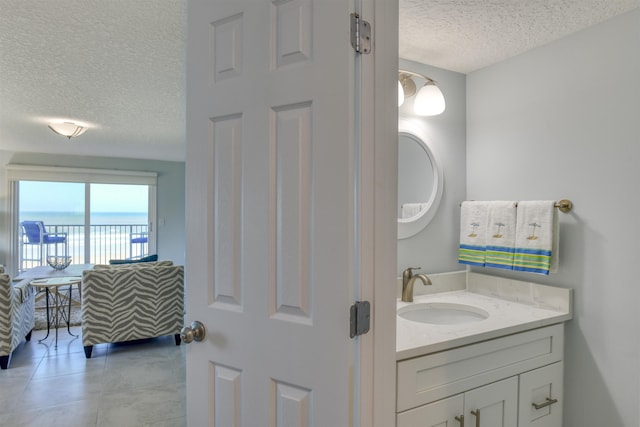 8550 S A1A # 102, Saint Augustine, FL 32080 - bathroom with a water view, tile patterned floors, vanity, and a textured ceiling
