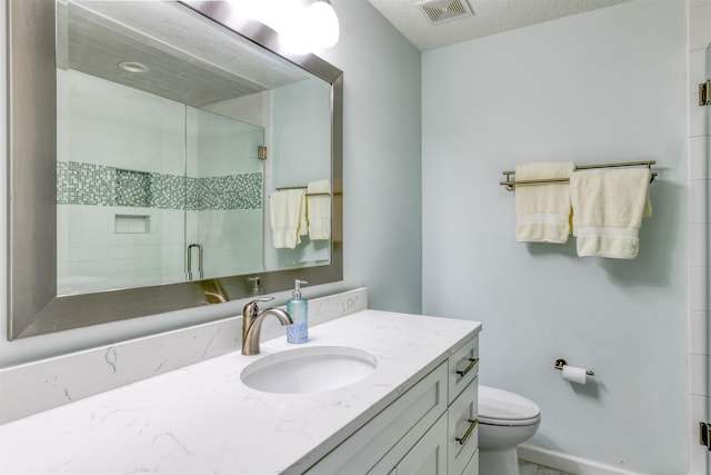 8550 S A1A # 102, Saint Augustine, FL 32080 - bathroom featuring visible vents, baseboards, toilet, vanity, and a stall shower