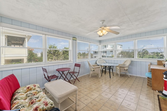 sunroom featuring a ceiling fan