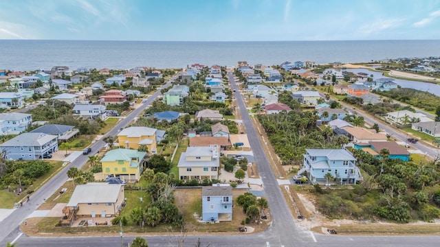 drone / aerial view featuring a water view and a residential view