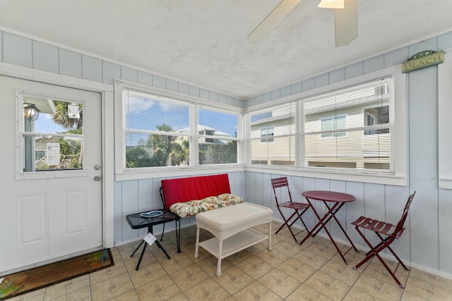 sunroom with a ceiling fan